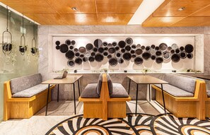 Relax in the central seating area with a comfortable bench and two matching tables.
