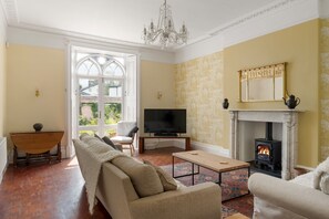 A living room with a fireplace, television, and seating area.