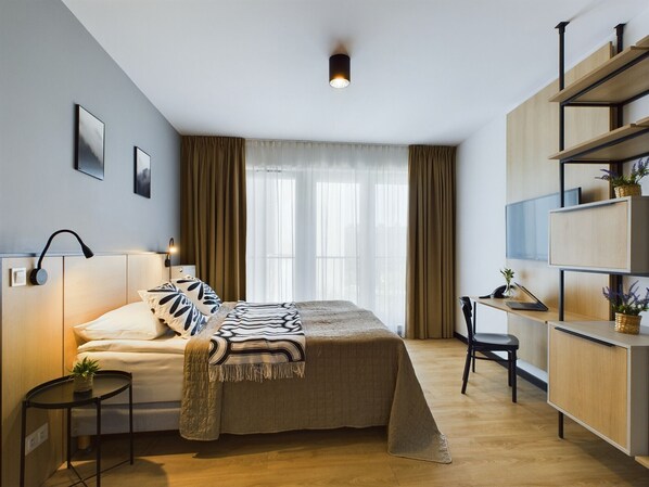 Desk, laptop workspace, bed sheets