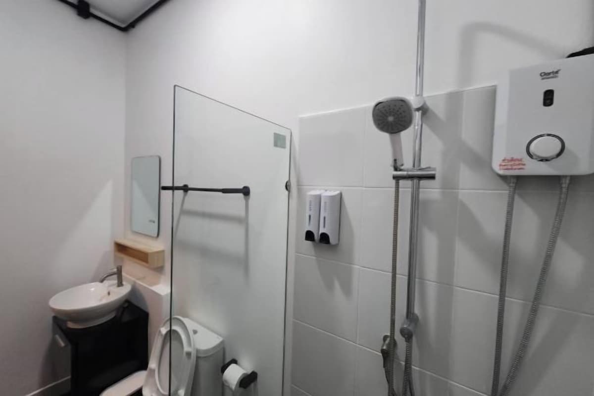 A modern bathroom with a toilet, sink, and shower.
