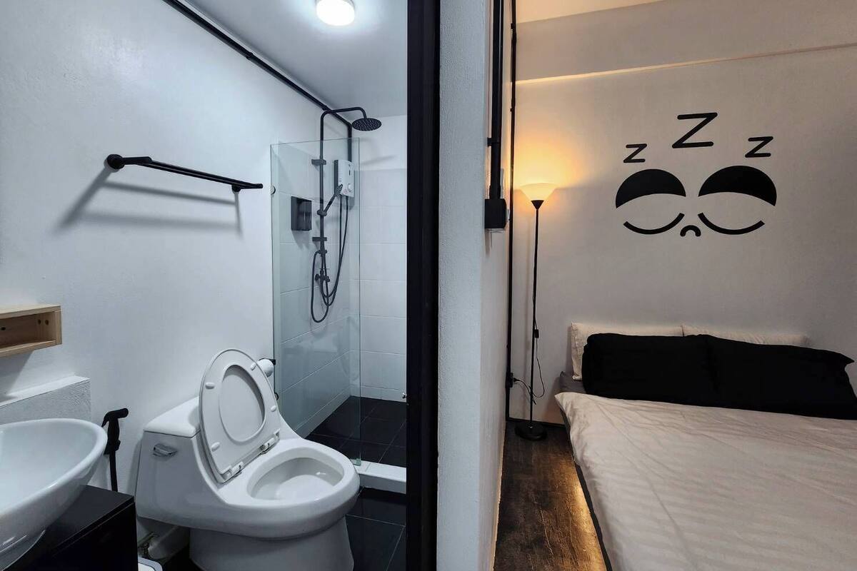 A modern bathroom with a toilet, sink, and shower.