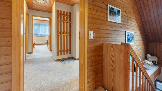 A wooden interior with a staircase, wooden walls, and a small animal sculpture. - Apartment 'Haus Stoldt, Wohnung 2' with Shared Terrace, Shared Garden and Wi-Fi (Meldorf)