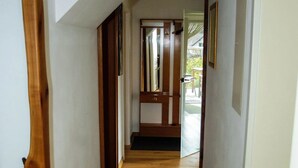 A wooden hallway with a door at the end, leading to an outdoor area. - Apartment 'Am Quellental' with Private Terrace, Private Garden and Wi-Fi (Meinerzhagen)