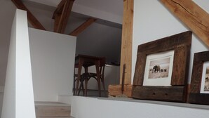 A staircase with wooden steps and a white wall. - Apartment 'Fewoimdorf' with Wi-Fi (Wertheim)