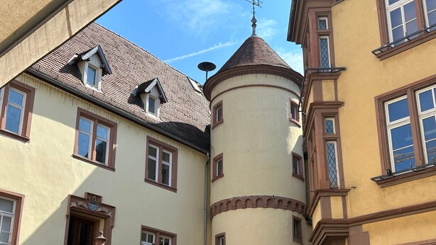 A building with a turret, multiple windows, and a staircase with a decorative railing. - Apartment 'Fewoimdorf' with Wi-Fi (Wertheim)