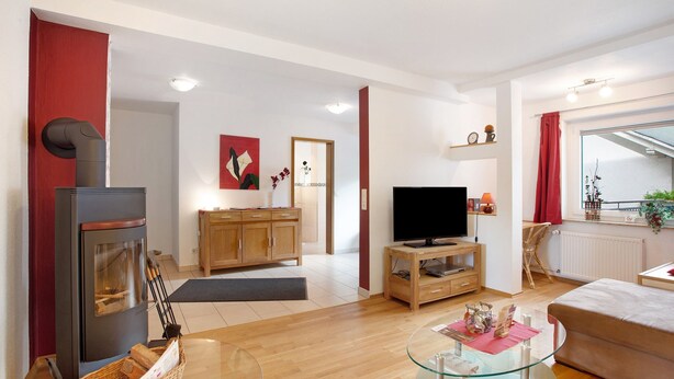 A modern living room with a fireplace, television, and wooden furniture.