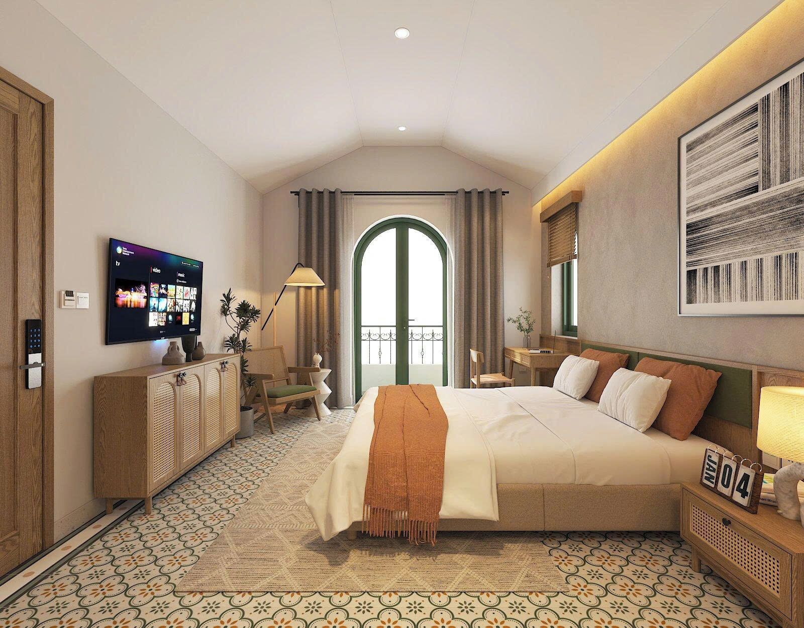 A modern hotel room with a large bed, a flat-screen TV mounted on the wall, a desk with a chair, a small table with a lamp, and a balcony with a view.
