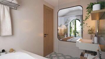 A modern bathroom with a large bathtub, a wooden door, a mirror reflecting a room with a view, and a shelf with toiletries.