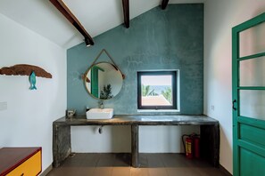 A bathroom with a rustic design, featuring a wooden vanity, a round mirror, and a window with a view. - Sea Easter 3BR Seaside An Bang Beach (Da Nang)