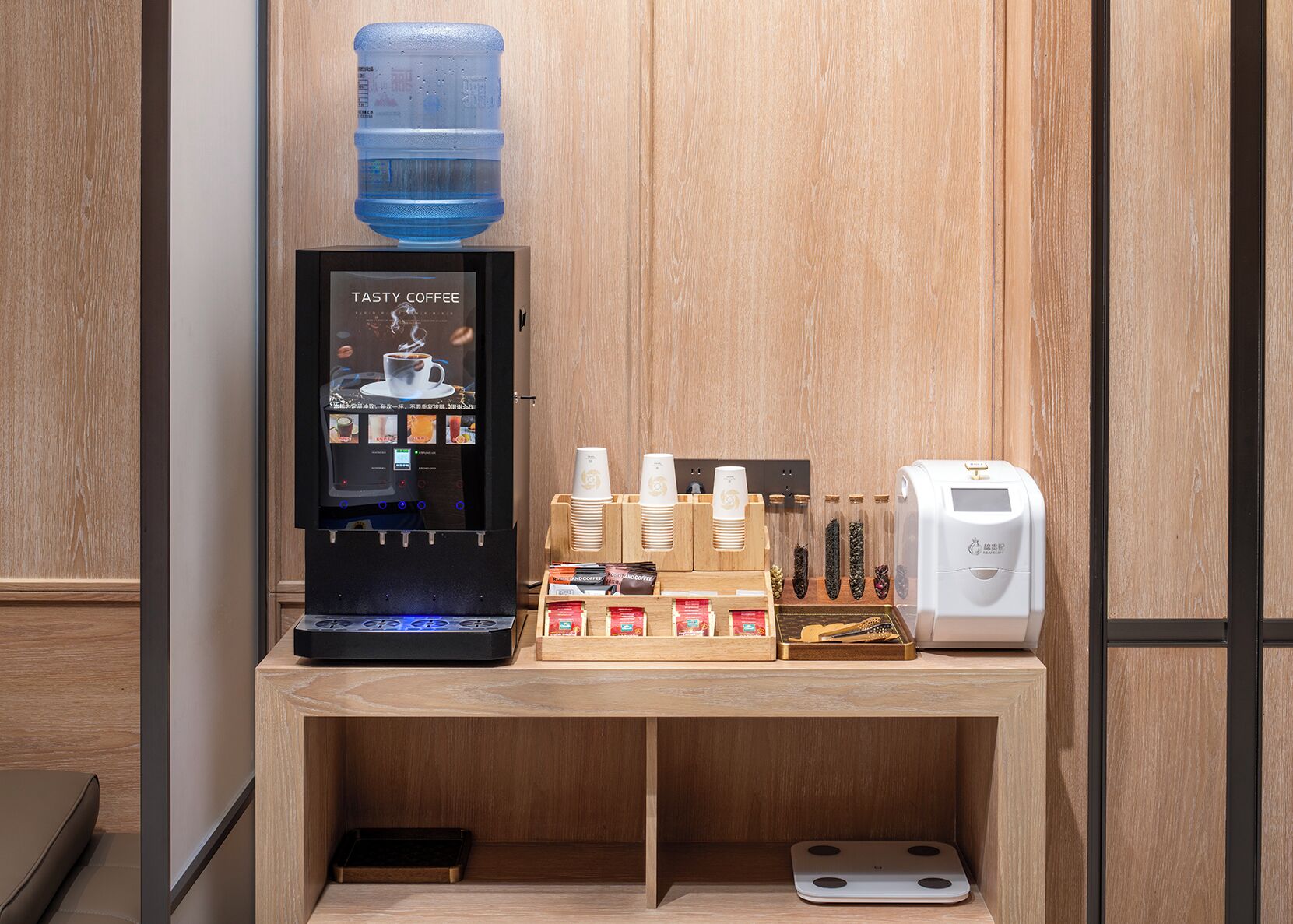 Un espace dédié au café, équipé d’une machine à café Tasty Coffee, de gobelets jetables et d’un distributeur d’eau.