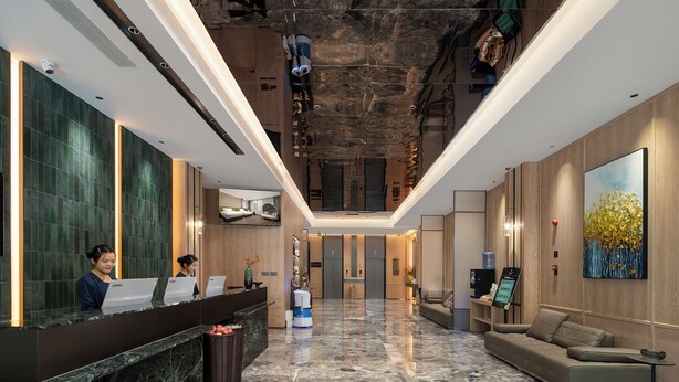 A modern hotel lobby with a reception desk, a seating area, and a large artwork on the wall. - Meihao Lizhi Hotel (Xi'an Lintong Huaqingchi Subway Station Branch) (Xi'an)