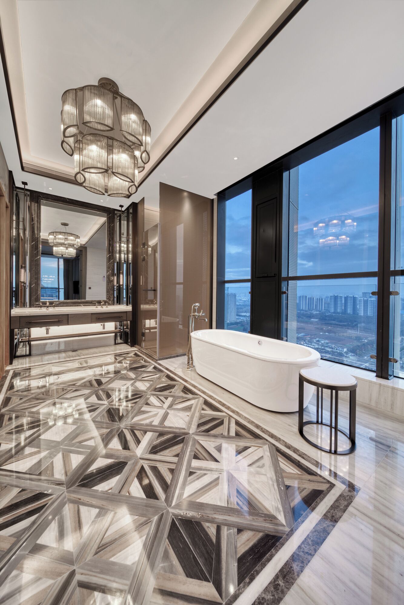 A spacious bathroom with a large bathtub, a walk-in shower, and a vanity with a mirror. The floor has a geometric tile pattern, and there is a large window offering a city view.