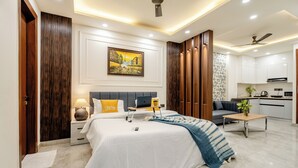 A modern bedroom with a bed, bedside tables, a desk, and a sofa. - Street Studio by Lime Tree Hotels (Gurugram)