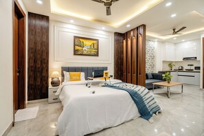 A modern bedroom with a bed, bedside tables, a desk, and a sofa. - Street Studio by Lime Tree Hotels (Gurugram)