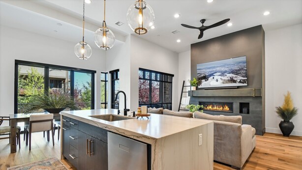 A modern kitchen with a large island, built-in appliances, and a dining area with a view. - Townhome w/Hot Tub | Walk to Ski Lift (Park City)