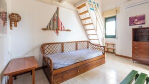 A room with a wooden bed, a small table, a ladder, and a wooden cabinet. - 4005 Villetta Stella by Barbarhouse (Manduria)