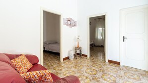 A room with a red sofa, patterned cushions, a lamp, and a 'HOME' sign on the wall. - 4087 Cascina Mimì by Barbarhouse (Nardò)