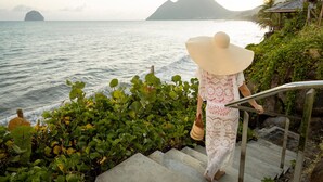 A staircase leading to a coastal area with a view of the sea and mountains. - Villa Koh-I-noor (Le Diamant)