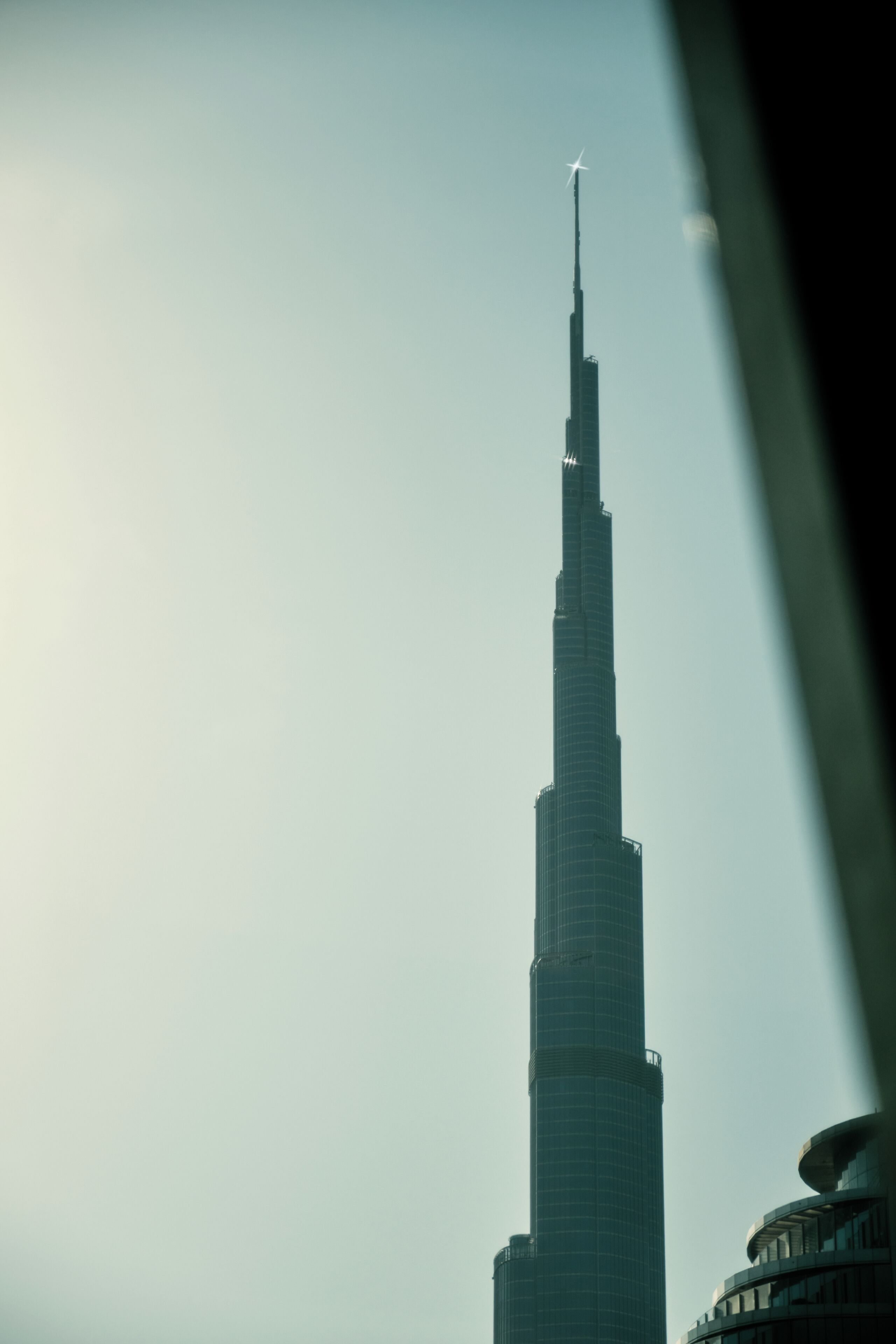 A tall, slender skyscraper with a pointed top, likely a modern architectural landmark.