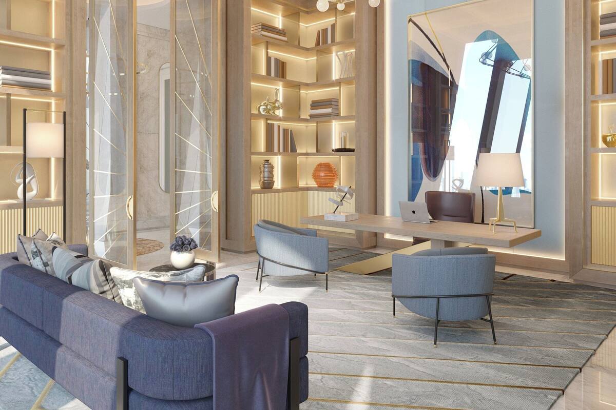 Un salon moderne comprenant un canapé, des fauteuils, une table basse et une bibliothèque.