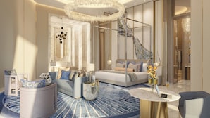 Une chambre d’hôtel moderne dotée d’un coin salon aux lignes courbes, d’une table basse ronde et d’un grand miroir.