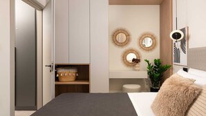 A bedroom with a bed, a wardrobe, a mirror, and a wall-mounted light fixture.