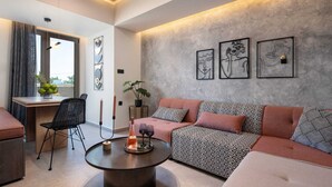 A modern living room with a sofa, a round coffee table, and artwork on the wall.