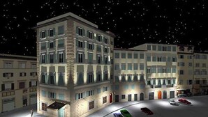 Un edificio de varios pisos con un área de estacionamiento al frente.