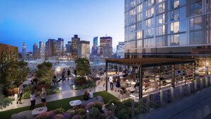A rooftop garden with seating areas, a bar, and a view of the city skyline at dusk. - Luxury Apt Near TD Garden (Boston)