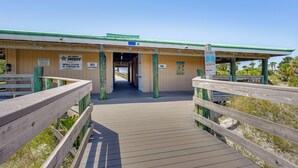 A beach patrol station with a wooden walkway leading to the entrance. - Panama City Home w/ Fire Pit - Walk to Beaches! (Panama City Beach)