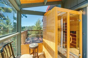 A wooden cabin with a glass door leading to a deck, a wooden bench, and a view of trees. - Scenic Home w/ Sauna - 7 Mi to Heavenly Mountain! (Stateline)