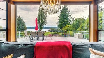 A cozy seating area with a view of a deck and outdoor furniture.