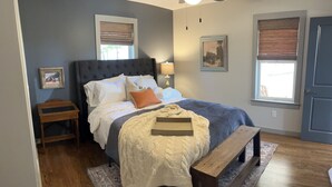 A bedroom with a bed, bedside tables, a bench, and a ceiling fan. -  Quaint,newly remodeled country cabin in the heart of Bourbon Country. (Raywick)