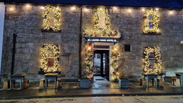 A stone building with a sign for the Laurel Bank Hotel. - The Wee Haig - 1 Bedroom Condo (Glenrothes)