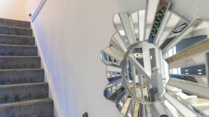 A spiral staircase with a modern, reflective design. - Jalebo (Cleethorpes)