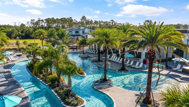 A resort with a large pool, palm trees, and lounge areas. - Epic Paradiso Mansion-Pool/Game Room/Theater-4 (Orlando)