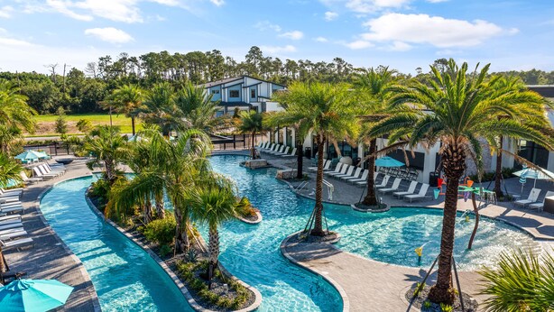 A resort with a large pool, palm trees, and lounge areas. - Epic Paradiso Mansion-Pool/Game Room/Theater-2 (Orlando)