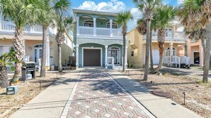 A two-story building with a covered entrance and a balcony. - Seaside Serenity (Panama City Beach)