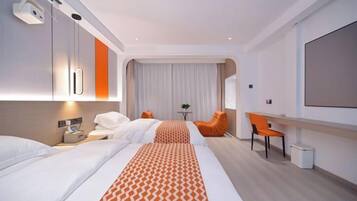 A hotel room with two beds, a desk, a chair, a TV, and a small table.