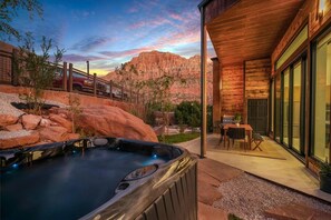 Relax in the hot tub with a view of the surrounding red rock formations.