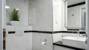 Een douche, handdoeken, zeep, shampoo