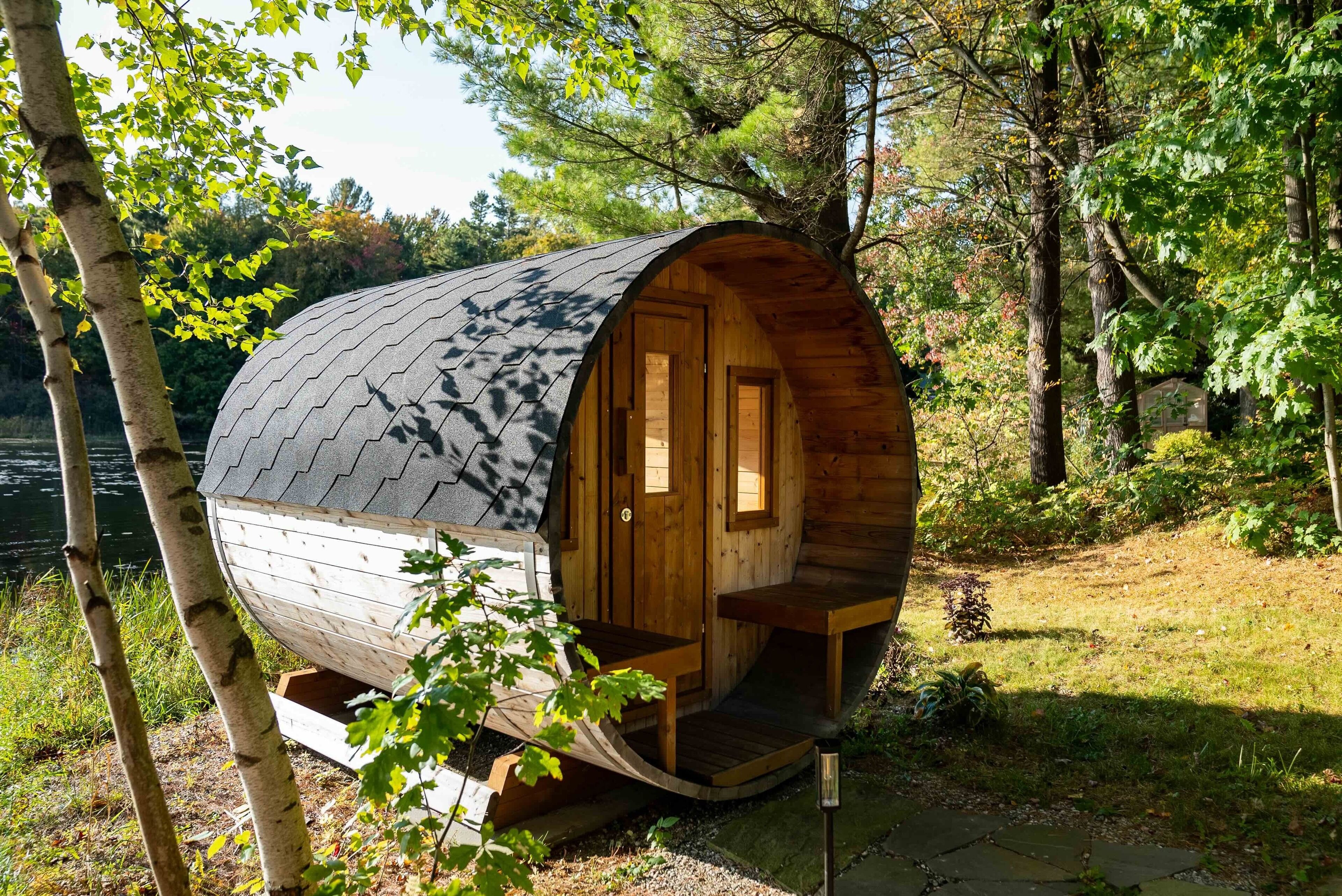 A wooden cabin with a curved roof, a wooden door, and a small porch.