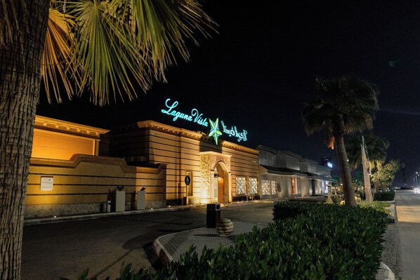 A hotel facade with a neon sign reading "Laguna Vista Hotel & Resort" at night. - Laguna Vista Hotel (Buraydah)