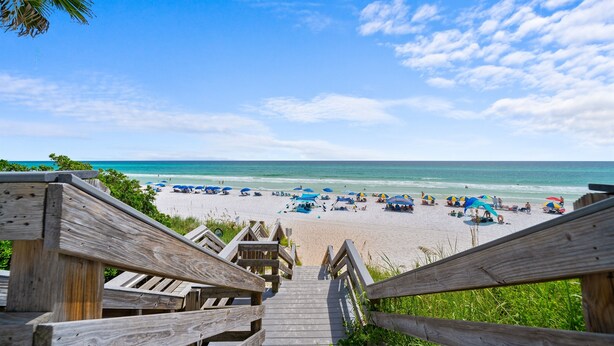 A wooden staircase leading to a beach with umbrellas and people. - 60 Secs to [Private] Beach Seagrove - Gulf views! (Seagrove)