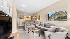 A modern living room with a sofa, coffee table, and a television. - Gac214c1 (Copper Mountain)