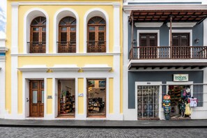 A two-story building with a shop on the ground floor and a balcony on the upper floor.