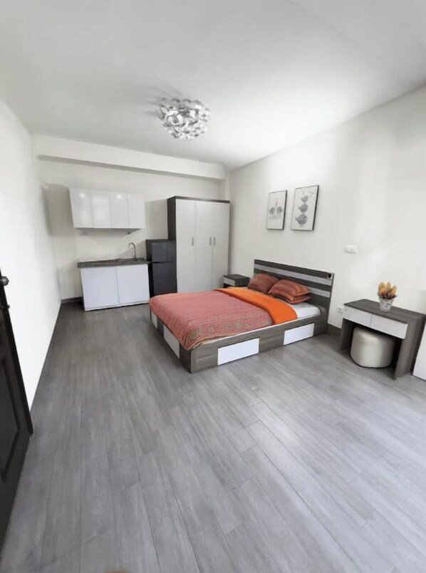 Cozy retreat with a single bed, bedside table, and wardrobe.