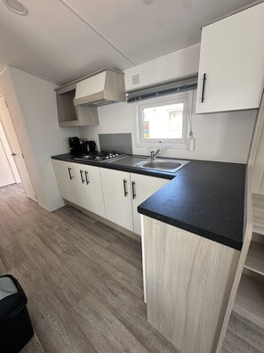Fridge, microwave, stovetop, coffee/tea maker