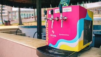 A colorful beverage dispenser with multiple taps, a spina logo, and a grill below it.