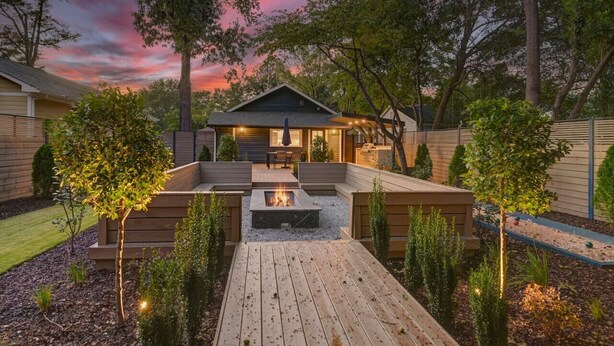 A backyard with a fire pit, wooden deck, and seating area. - The Indigo - 2BR w/Hot Tub & Outdoor Space (Columbia)